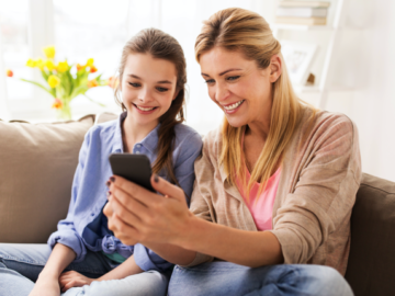 Mom and Daughter looking at Twigby phone