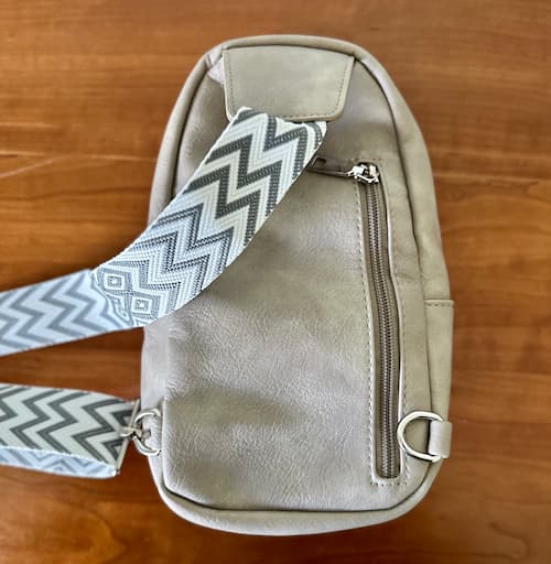 Cluci Small Sling Bag in Gray back with zipper pouch on dresser