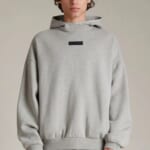 male model wearing a gray essentials hoodie